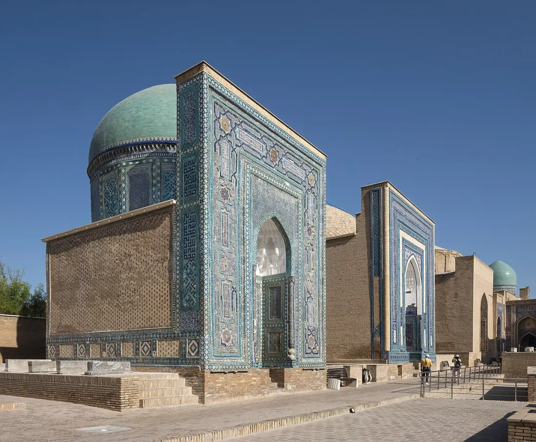 Tiled mausoleums with turquoise domes under a clear sky at Shah-i-Zinda in Samarkand.