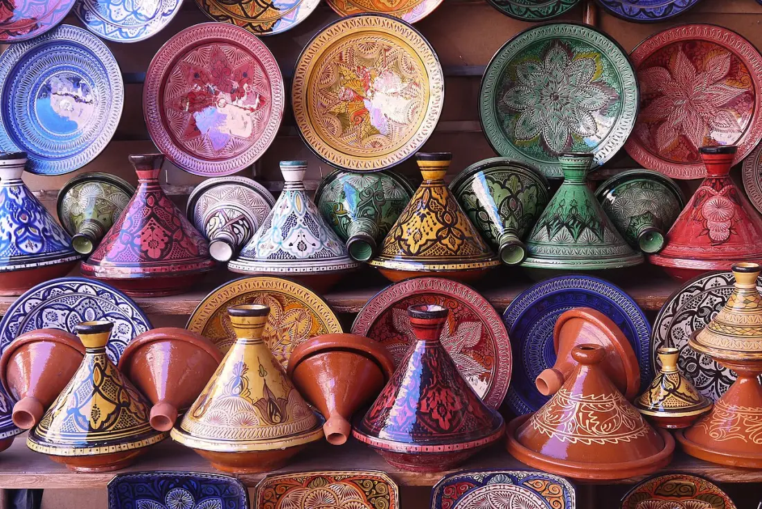 Shelves of brightly painted tajines and plates in a pottery shop in Morocco.